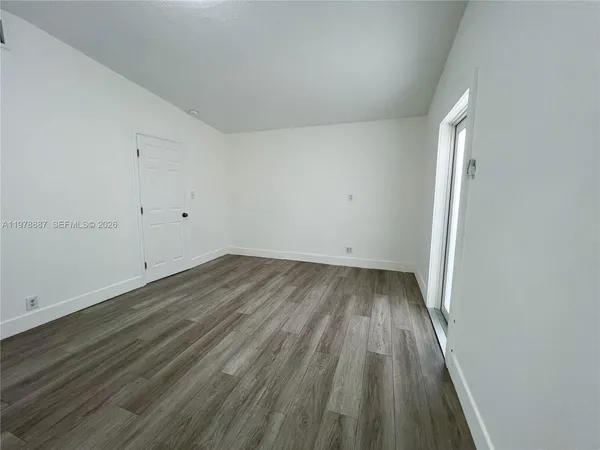a view of a room with wooden floor