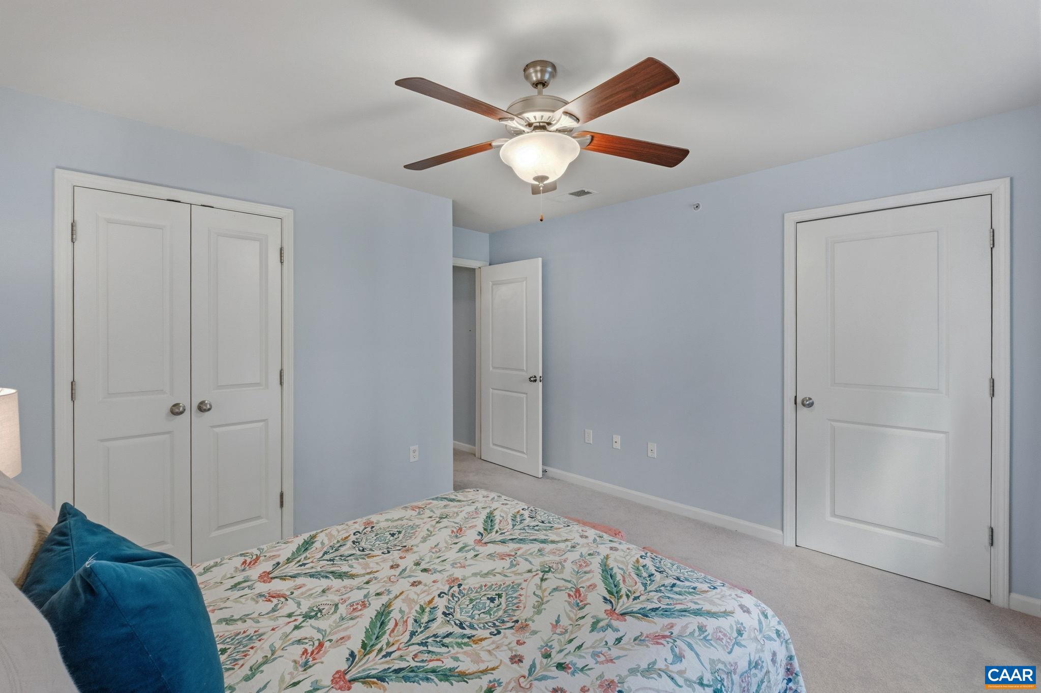 720 Walker Square, Unit 1B Charlottesville, VA 22903 - Photo 16 of 29 a bedroom with a large bed and a chandelier