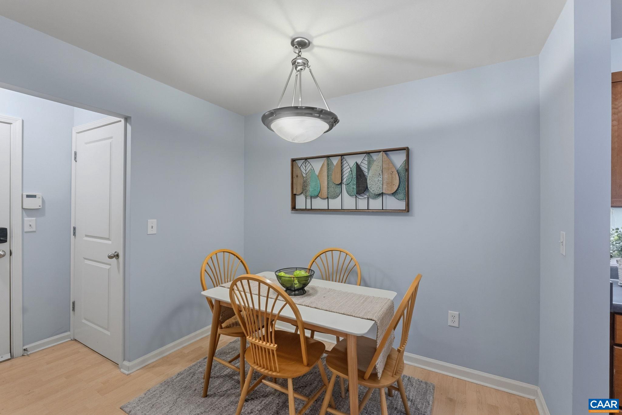 720 Walker Square, Unit 1B Charlottesville, VA 22903 - Photo 4 of 29 a view of a dining room with furniture and wooden floor