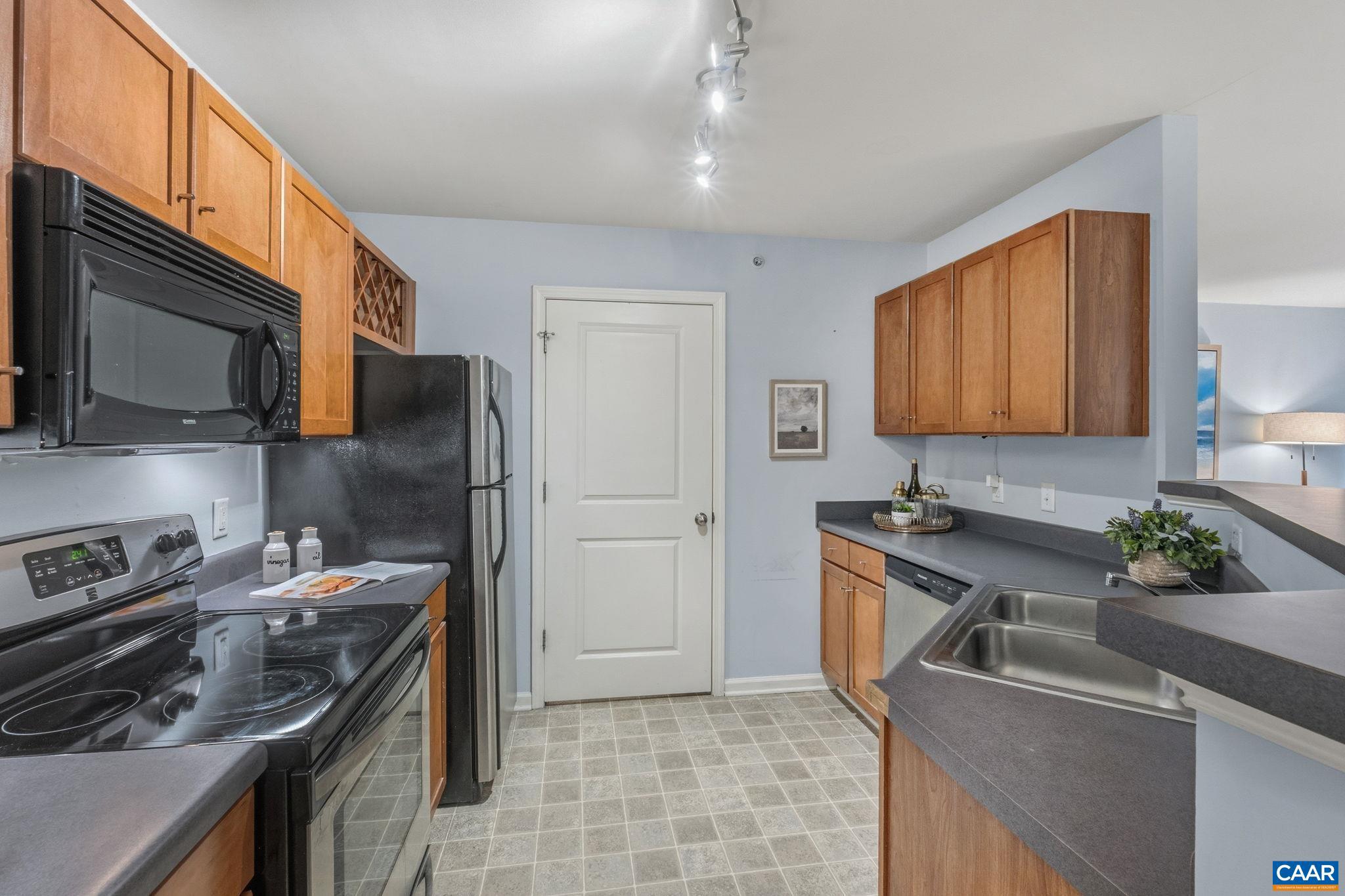 720 Walker Square, Unit 1B Charlottesville, VA 22903 - Photo 7 of 29 a kitchen with stainless steel appliances granite countertop a sink stove and refrigerator