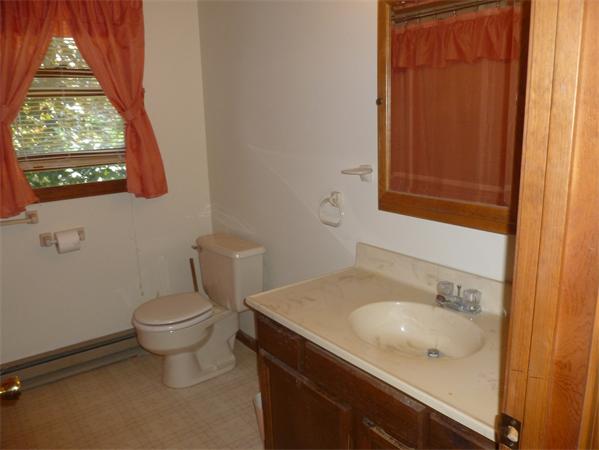196 Mazarin Street Springfield, MA 01151 - Photo 5 of 25 a bathroom with a granite countertop sink and a toilet