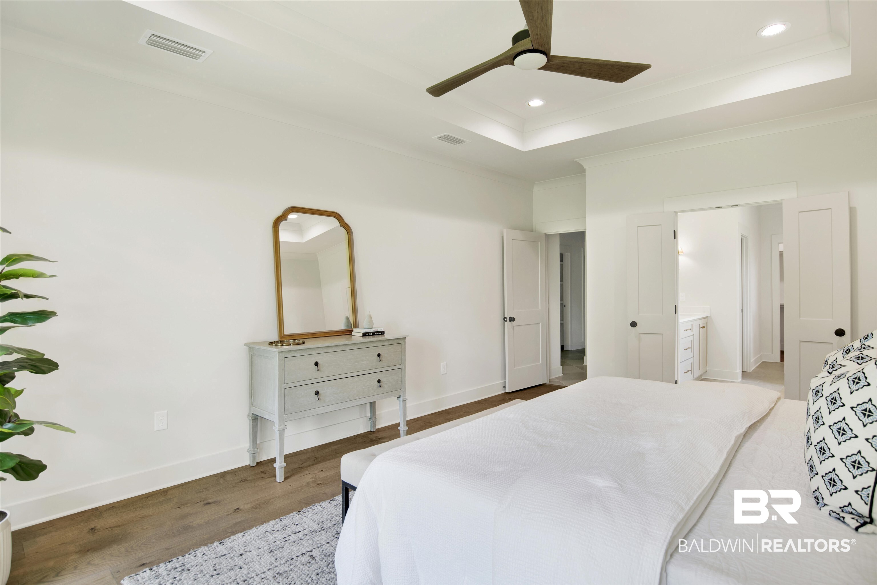 9275 Clarke Ridge Road Foley, AL 36535 - Photo 23 of 43 Bedroom with light wood-style flooring, a tray ceiling, recessed lighting, baseboards, and crown molding