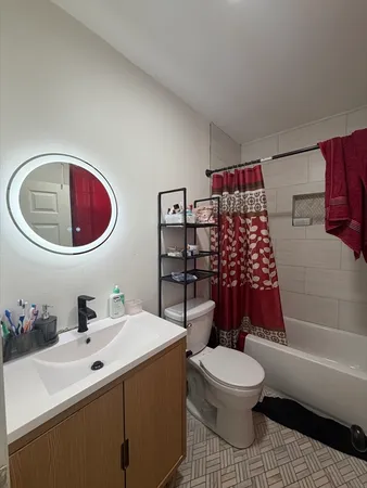 a bathroom with a toilet a sink and a bathtub
