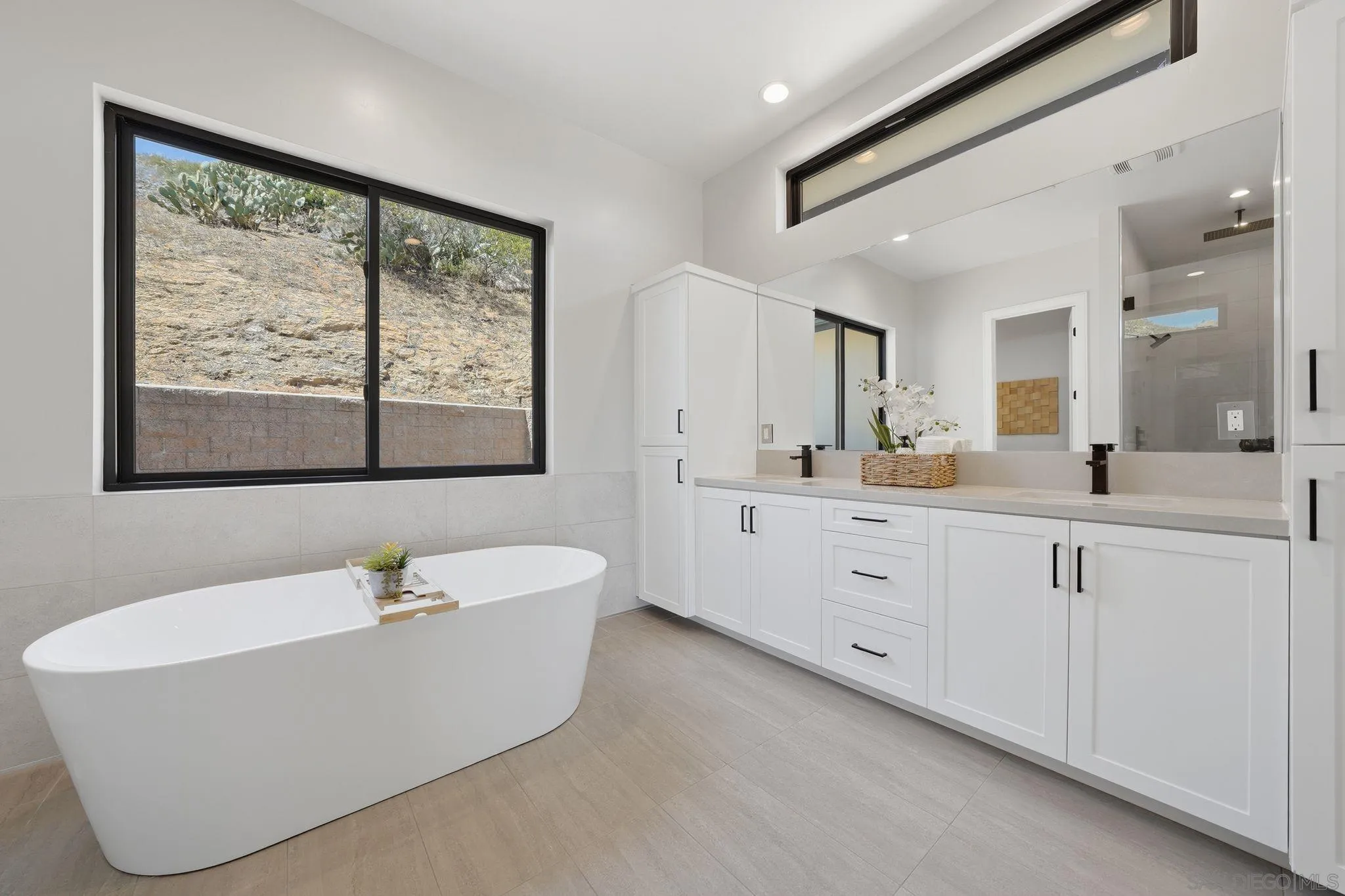 3916 Citrus Drive Fallbrook, CA 92028 - Photo 30 of 72 a spacious bathroom with a double vanity sink a large mirror a bathtub and window