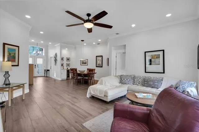 a living room with furniture and a wooden floor