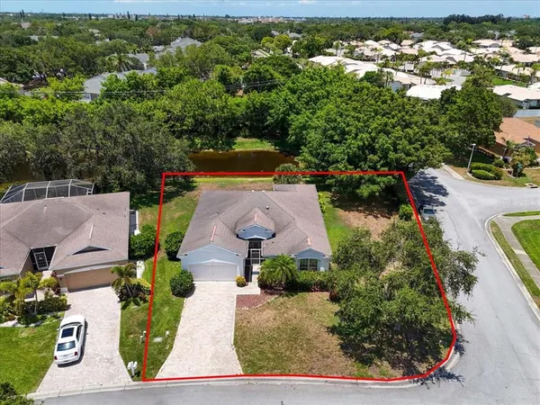 an aerial view of a house with yard swimming pool and outdoor seating