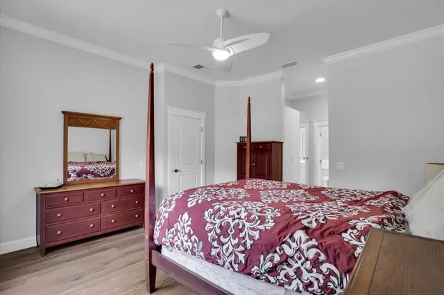 a bedroom with a bed and a dresser in it