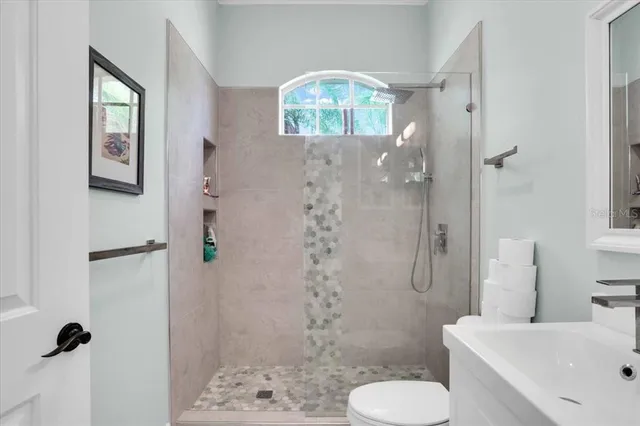 a bathroom with a sink toilet and shower