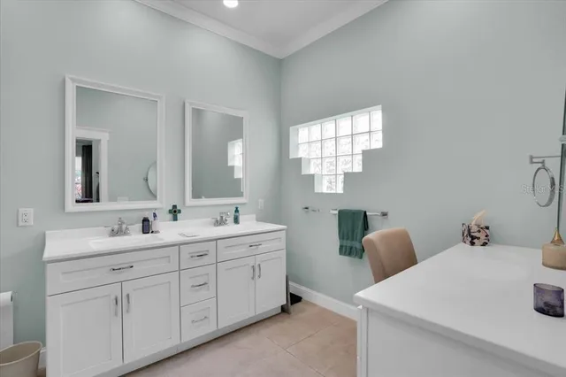 a bathroom with double sink and a window