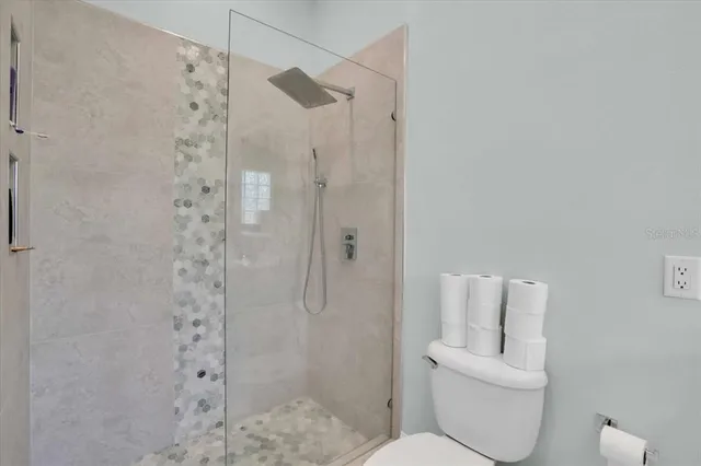 a bathroom with a toilet and shower