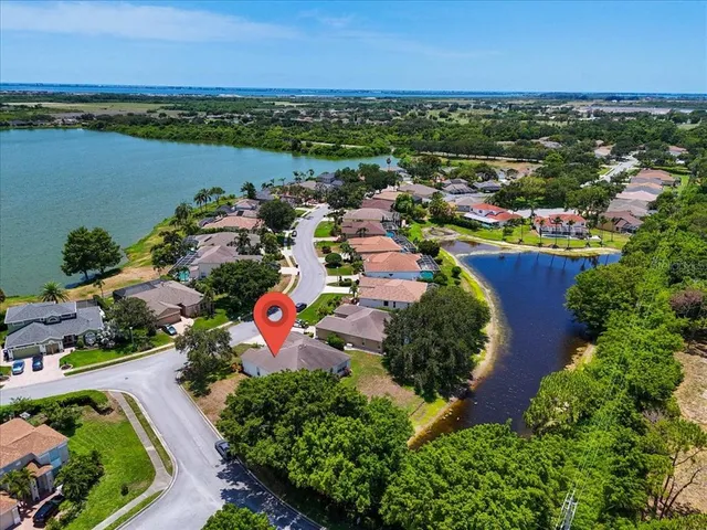 an aerial view of residential houses with outdoor space and river