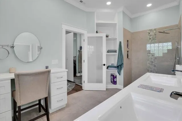 a en suite bathroom with a sink a toilet a shower and a mirror