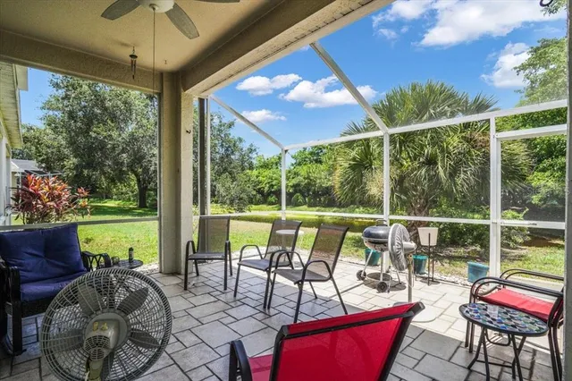 a view of a chairs and table in patio with a yard