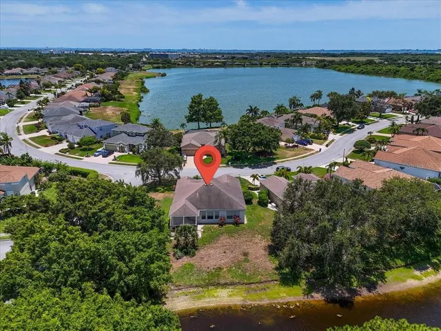 an aerial view of ocean and residential houses with outdoor space and lake view