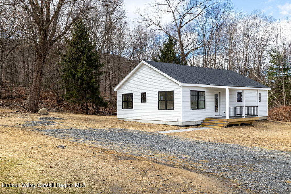 217 Anthony Street Copake, NY 12529 - Photo 1 of 23 a view of a white house with a large yard and large trees