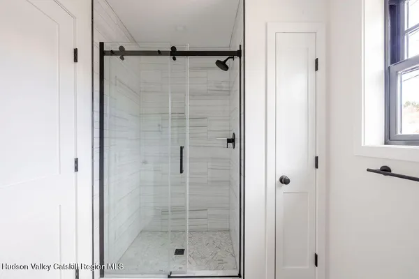 a bathroom with a glass shower door