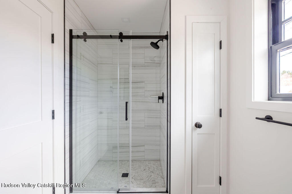 217 Anthony Street Copake, NY 12529 - Photo 16 of 23 a bathroom with a glass shower door