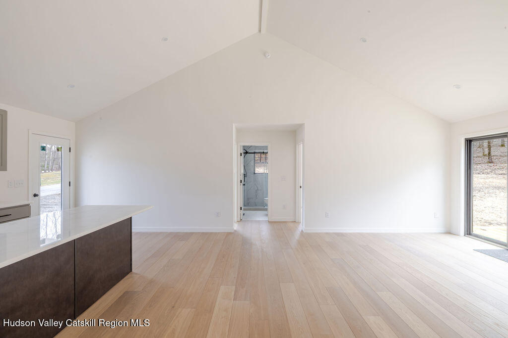 217 Anthony Street Copake, NY 12529 - Photo 8 of 23 a view of an empty room with wooden floor and a window