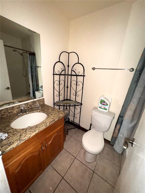 5310 Pebble Beach Drive, Unit F022 Orlando, FL 32811 - Photo 12 of 22 a spacious bathroom with a granite countertop sink mirror vanity and toilet