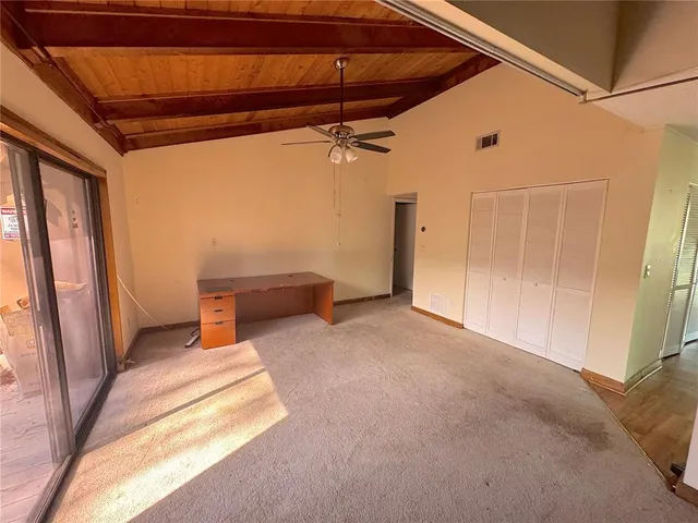 a view of a room with wooden walls and stairs