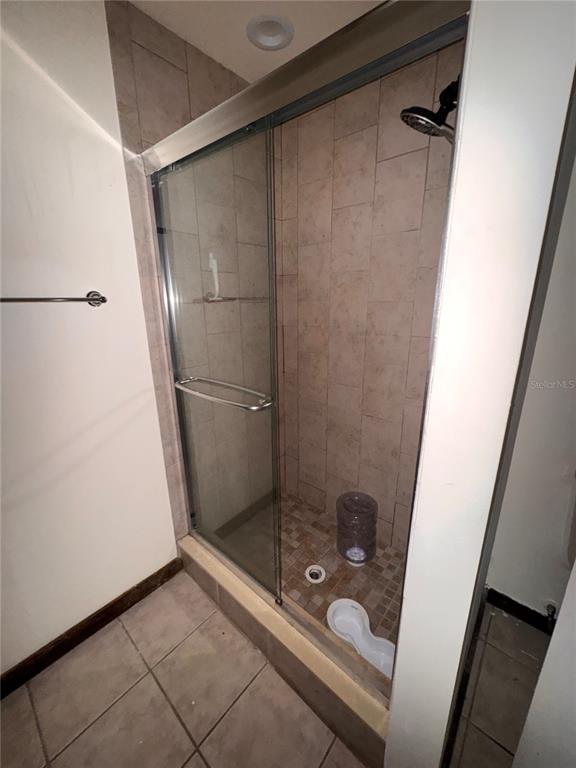5310 Pebble Beach Drive, Unit F022 Orlando, FL 32811 - Photo 10 of 22 a bathroom with a glass shower door