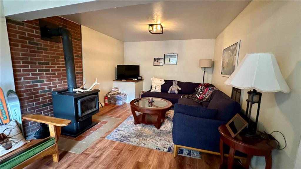 2525 Oakhill Road Gibsonia, PA 15044 - Photo 25 of 36 OTHER SIDE OF LOWER LEVEL FAMILY ROOM SHOWING OFF THE FABULOUS WOOD BURNING STOVE AMONGST A BRICK BACKGROUND!