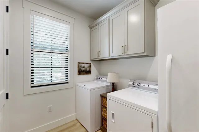 a view of kitchen with stainless steel appliances kitchen island refrigerator stove and wooden floor