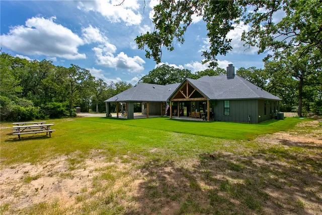 a view of a house with backyard porch and sitting area