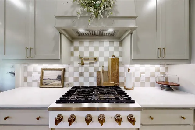 a kitchen with stainless steel appliances granite countertop a sink a stove and a refrigerator