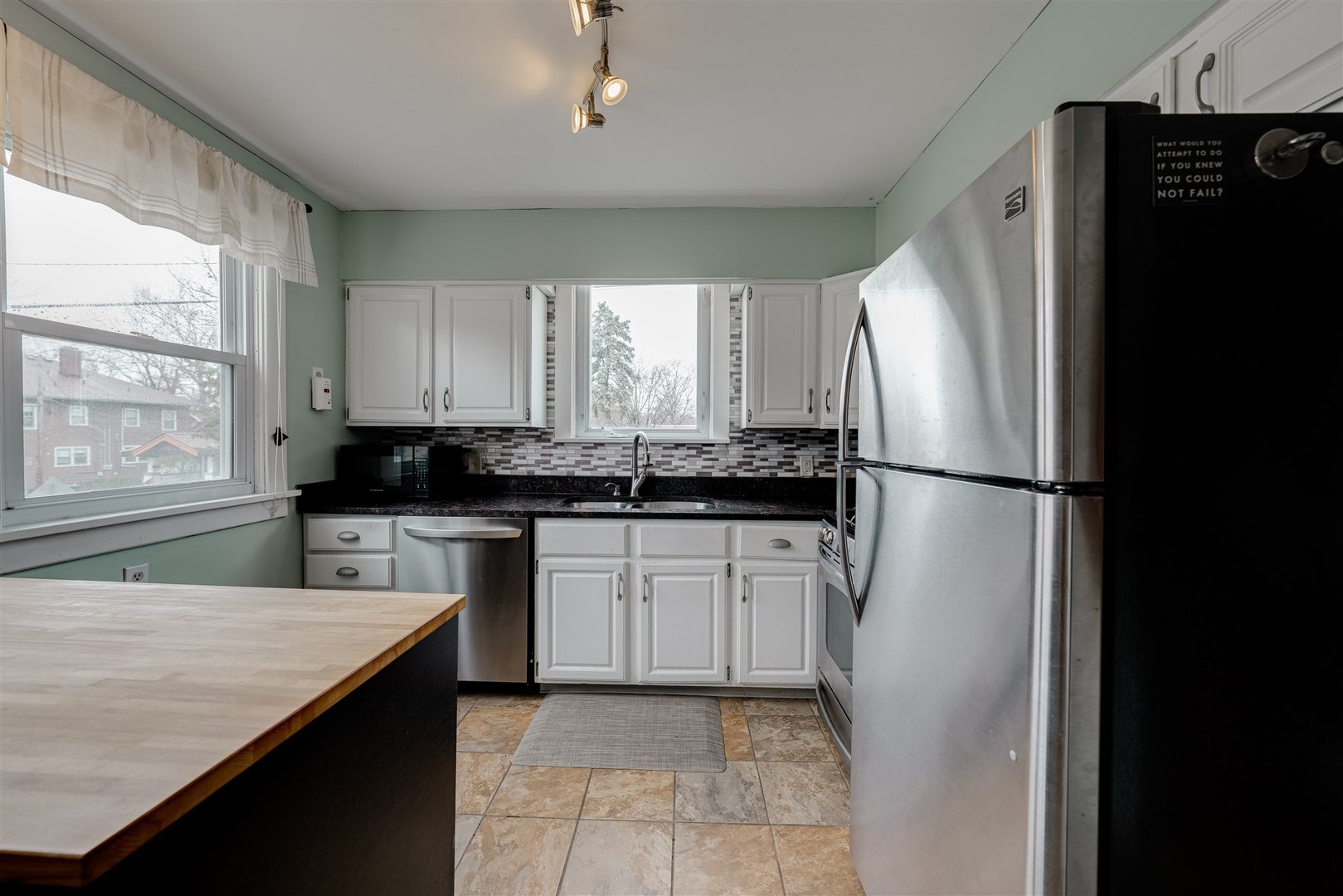 58 White Place Bloomington, IL 61701 - Photo 15 of 38 a kitchen with a refrigerator and a sink