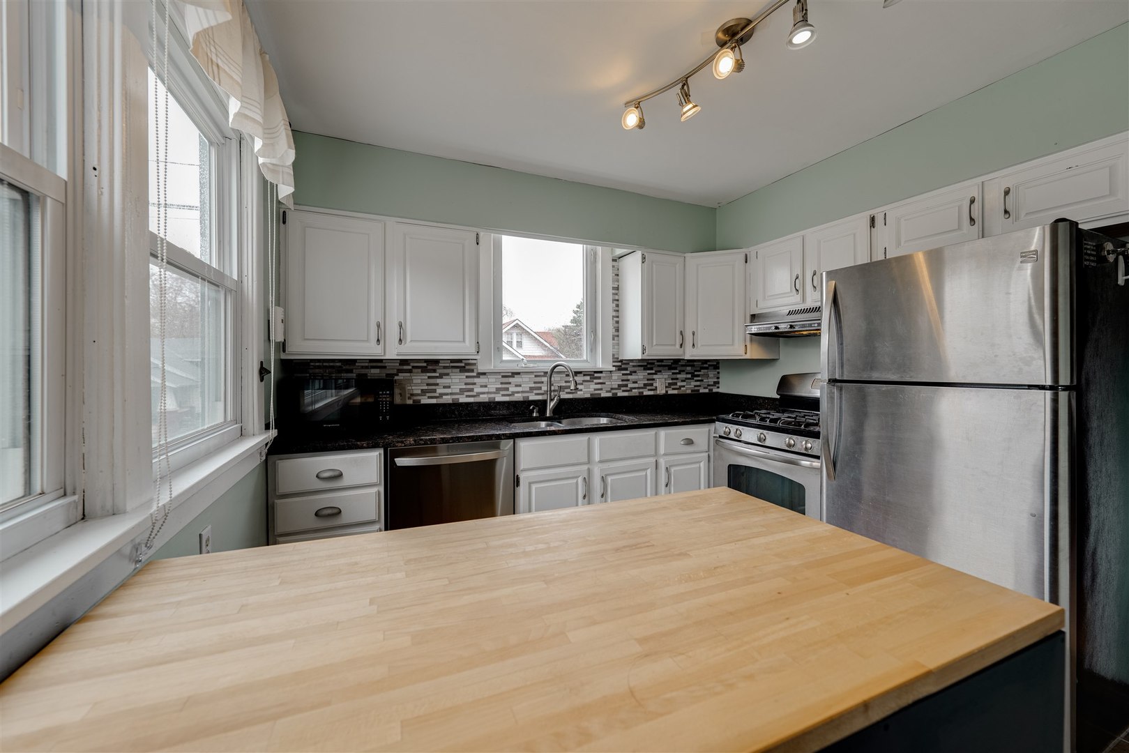 58 White Place Bloomington, IL 61701 - Photo 16 of 38 a kitchen with granite countertop a refrigerator stove top oven and sink