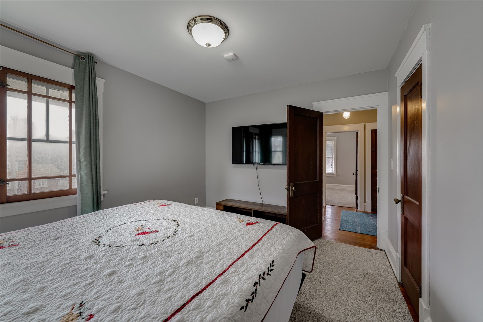 58 White Place Bloomington, IL 61701 - Photo 26 of 38 a bedroom with a bed and a flat tv screen on dresser