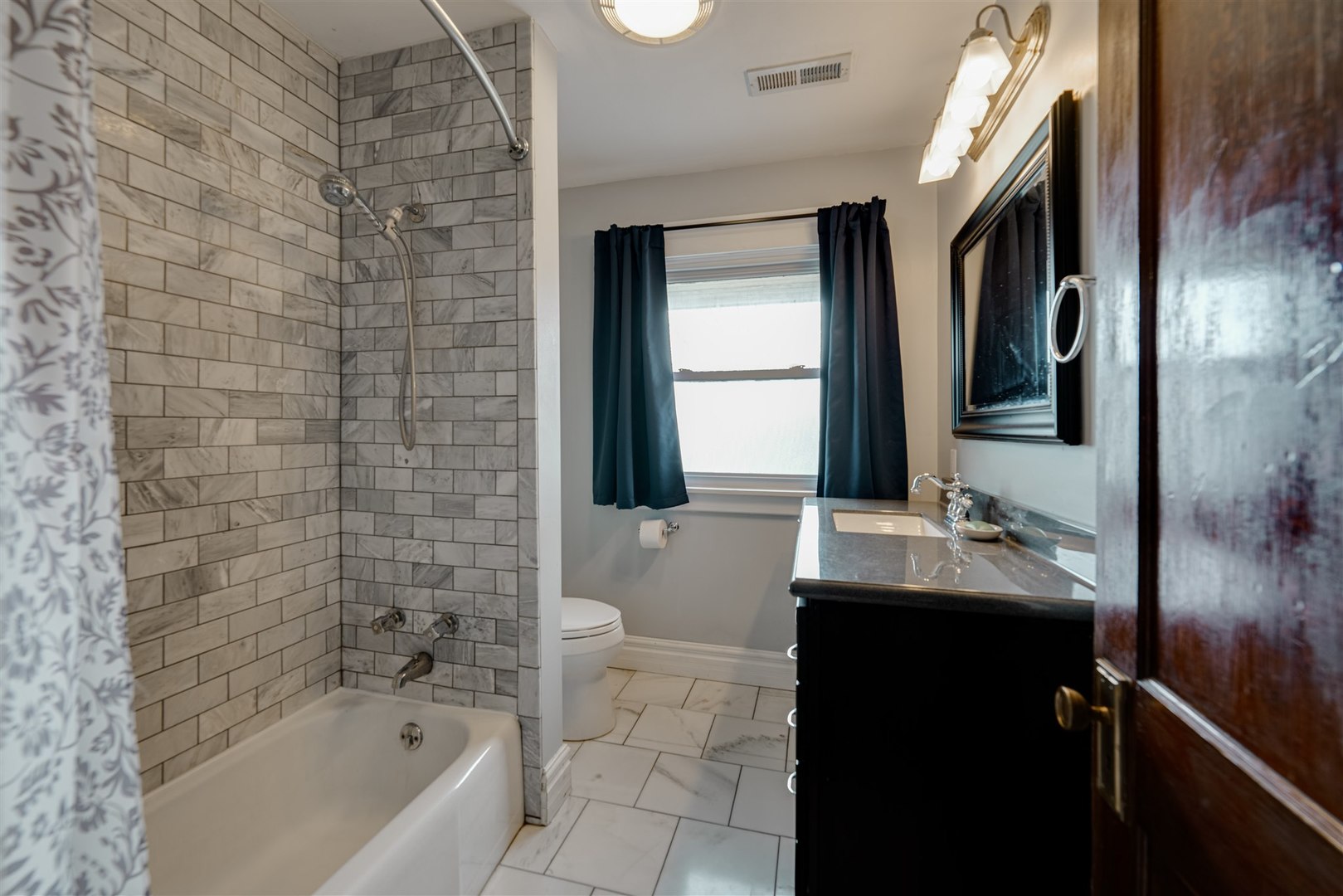 58 White Place Bloomington, IL 61701 - Photo 27 of 38 a bathroom with a bathtub sink vanity and a mirror