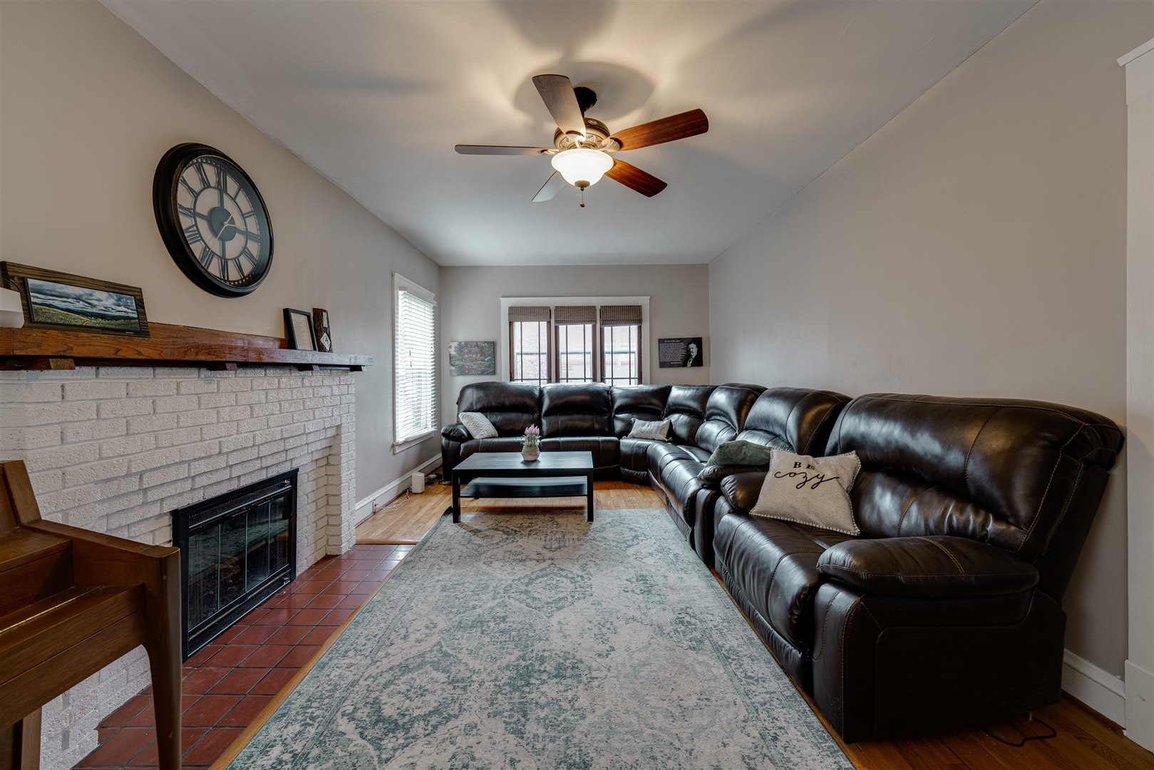 58 White Place Bloomington, IL 61701 - Photo 9 of 38 a living room with furniture a clock and a fireplace