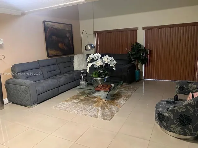 a living room with furniture flowerpot and a potted plant