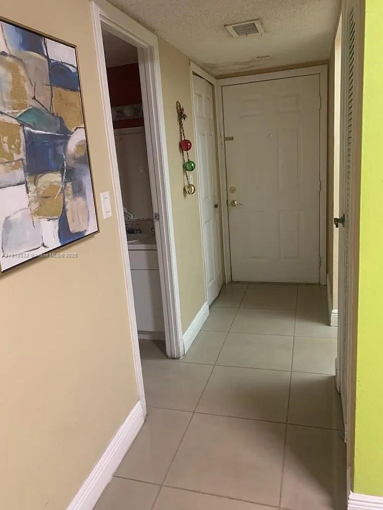 18051 Northwest 68th Avenue, Unit L104 Hialeah, FL 33015 - Photo 5 of 9 a view of an empty room with a window