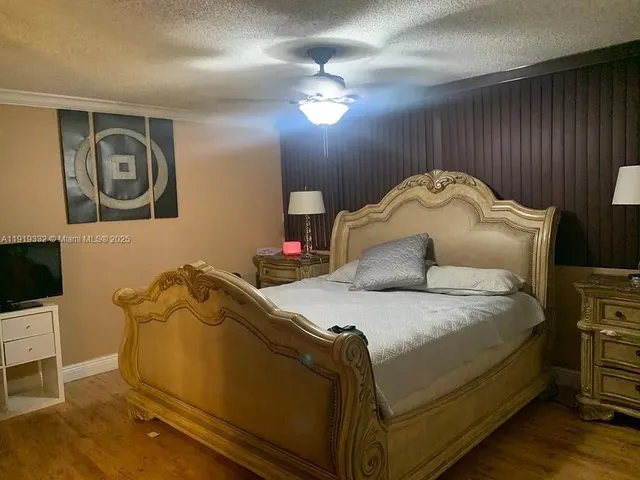 a bedroom with a bed and a tv