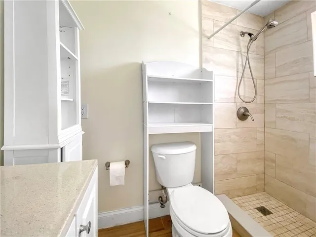 a white toilet sitting next to a bath tub shower