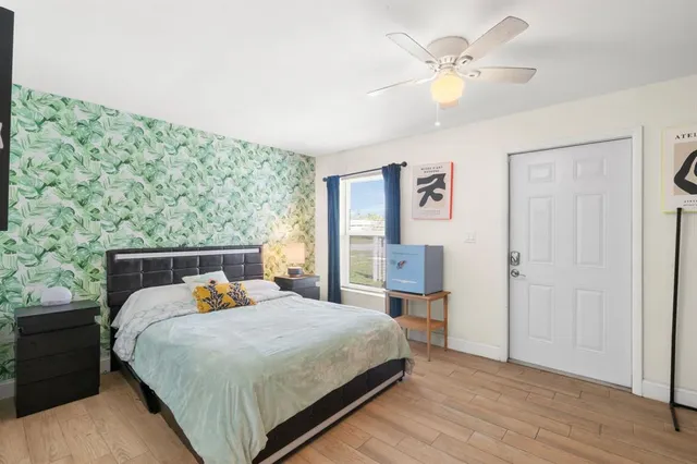 a bed sitting in a bedroom and chandelier