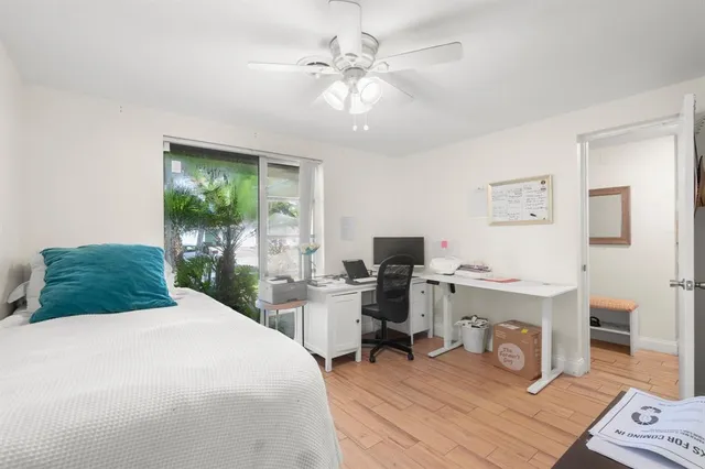 a bedroom with a bed a desk and chair