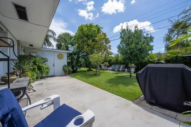 a view of backyard with outdoor seating and green space