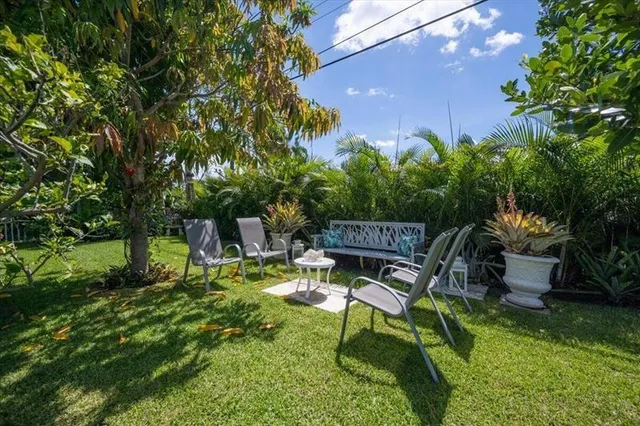 a backyard of a house with table and chairs