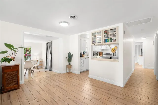 a living room with furniture and a kitchen area