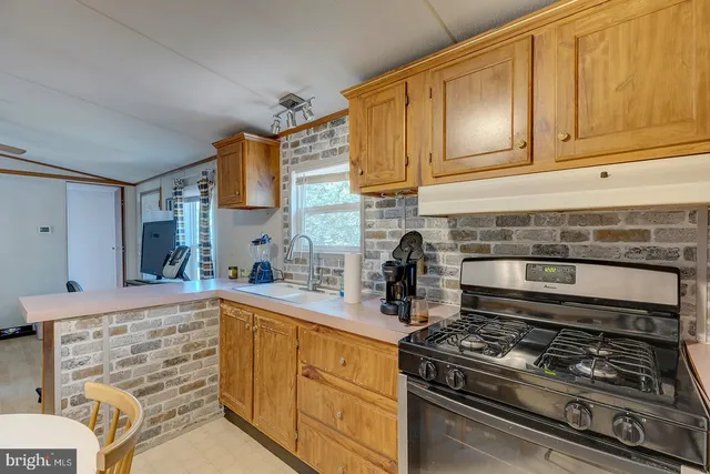 a kitchen with stainless steel appliances a stove and cabinets