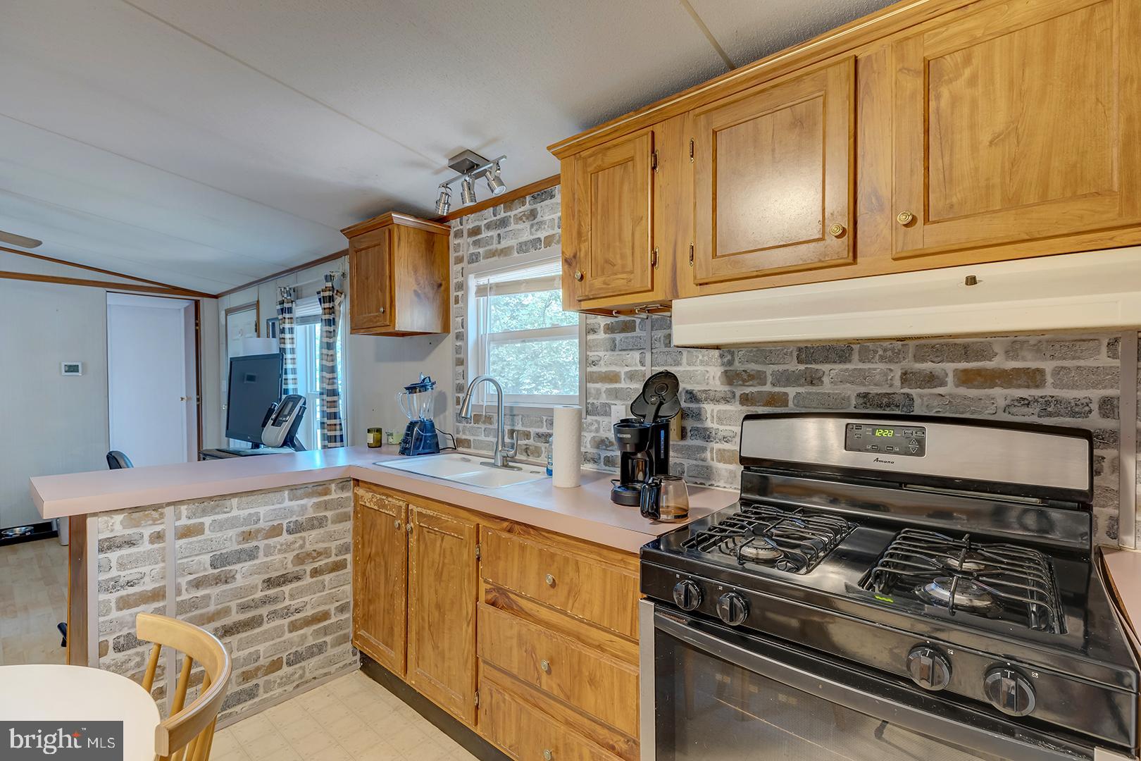 24119 Celtic Street Georgetown, DE 19947 - Photo 11 of 45 a kitchen with stainless steel appliances a stove and cabinets