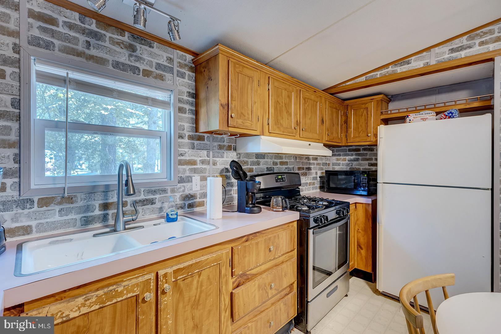 24119 Celtic Street Georgetown, DE 19947 - Photo 12 of 45 a kitchen with stainless steel appliances a refrigerator sink and cabinets
