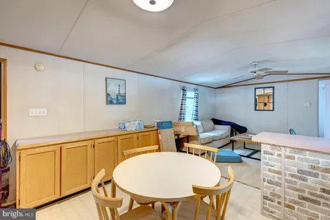a living room with furniture a window and a flat screen tv