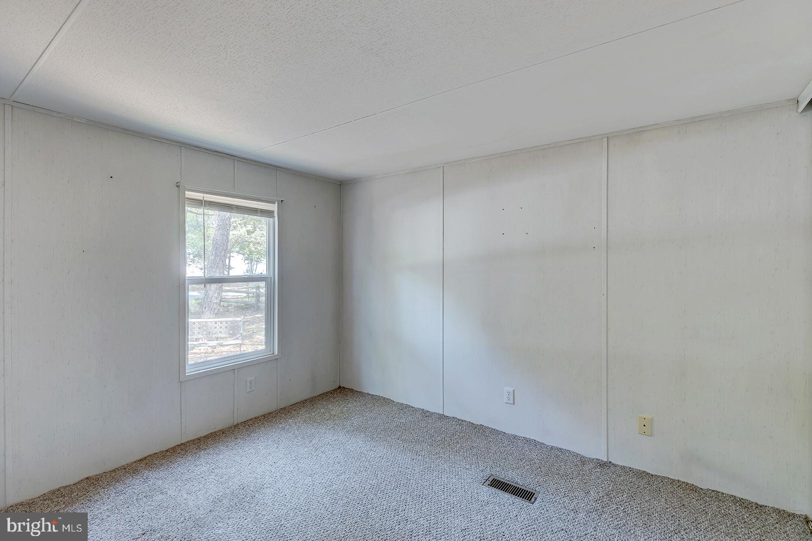 24119 Celtic Street Georgetown, DE 19947 - Photo 17 of 45 an empty room with windows