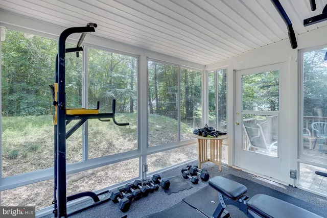 a room with furniture and a floor to ceiling window