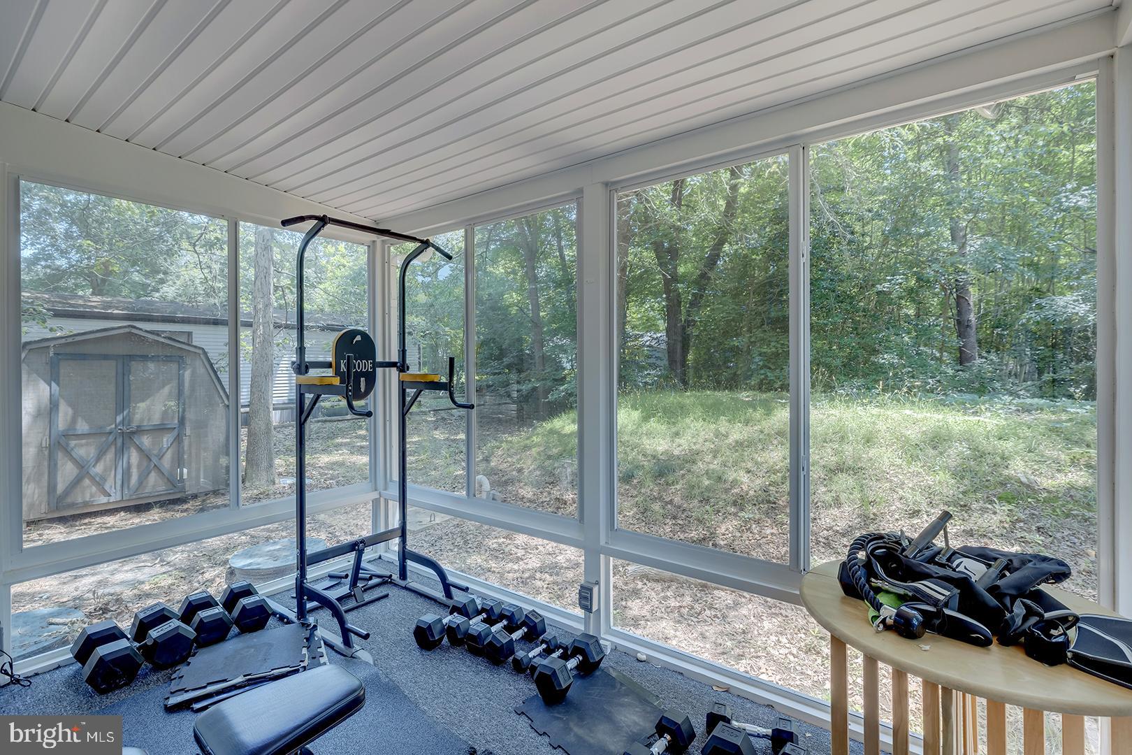 24119 Celtic Street Georgetown, DE 19947 - Photo 22 of 45 a room with furniture and a floor to ceiling window